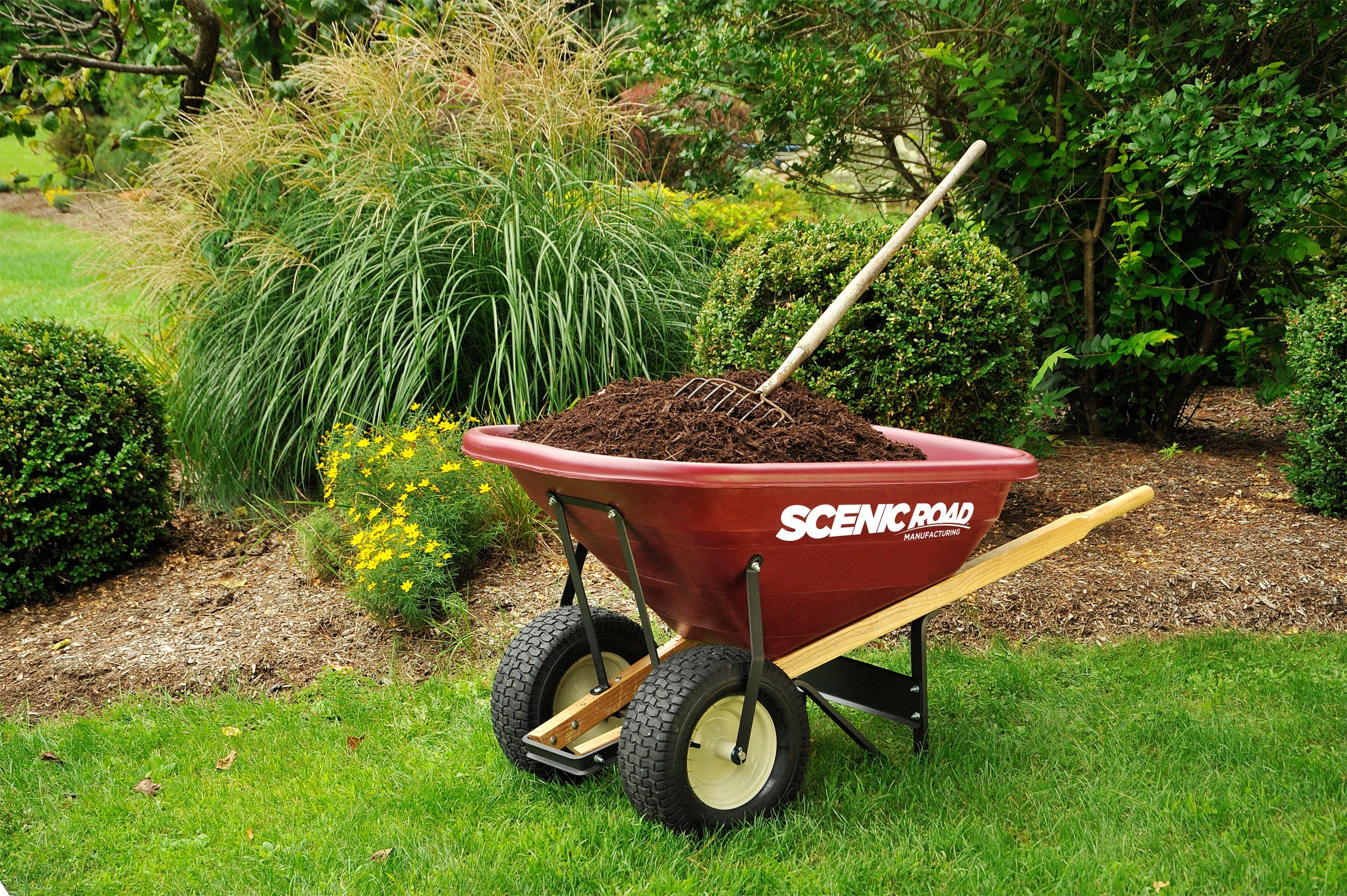 Scenic Road G-Series wheelbarrow in garden with mulch