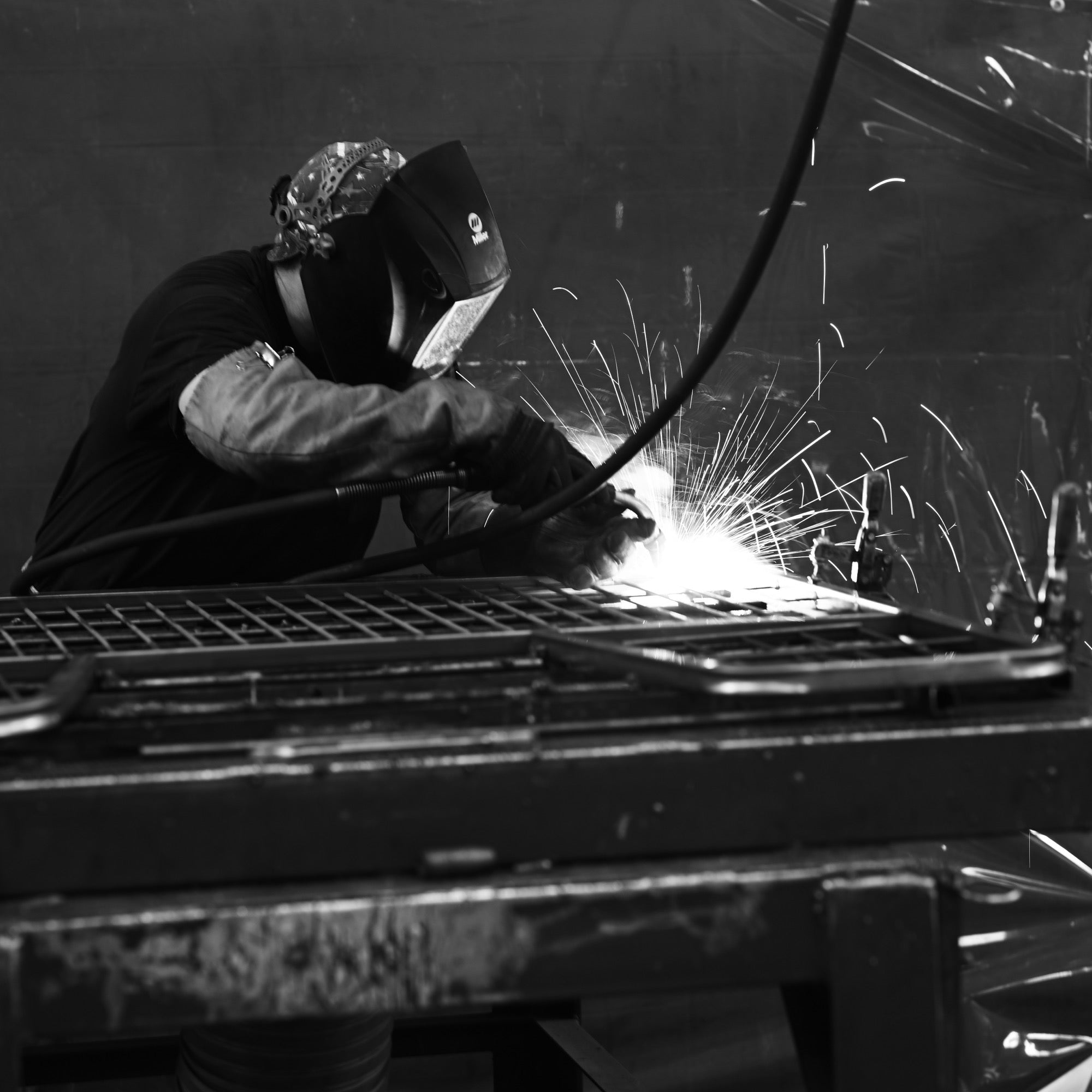 A Scenic Road craftsman welding a steel wheelbarrow undercarriage in the Denver, Pennsylvania shop
